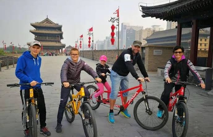 Family enjoying a bicycle ride on Xi’an’s historic city wall